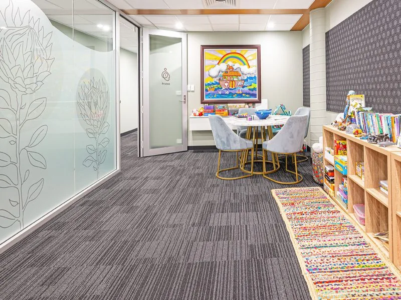 Playroom interior with children's table and toy shelves