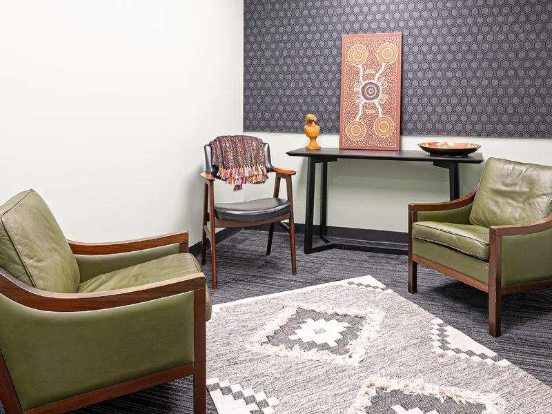 Standard suite with two green armchairs